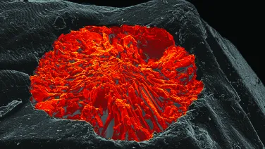 A grey rocky-looking formation with a red highlighted volcano shape in the middle